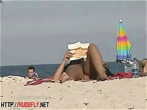 sizzling stunners filmed lying on a nudist beach